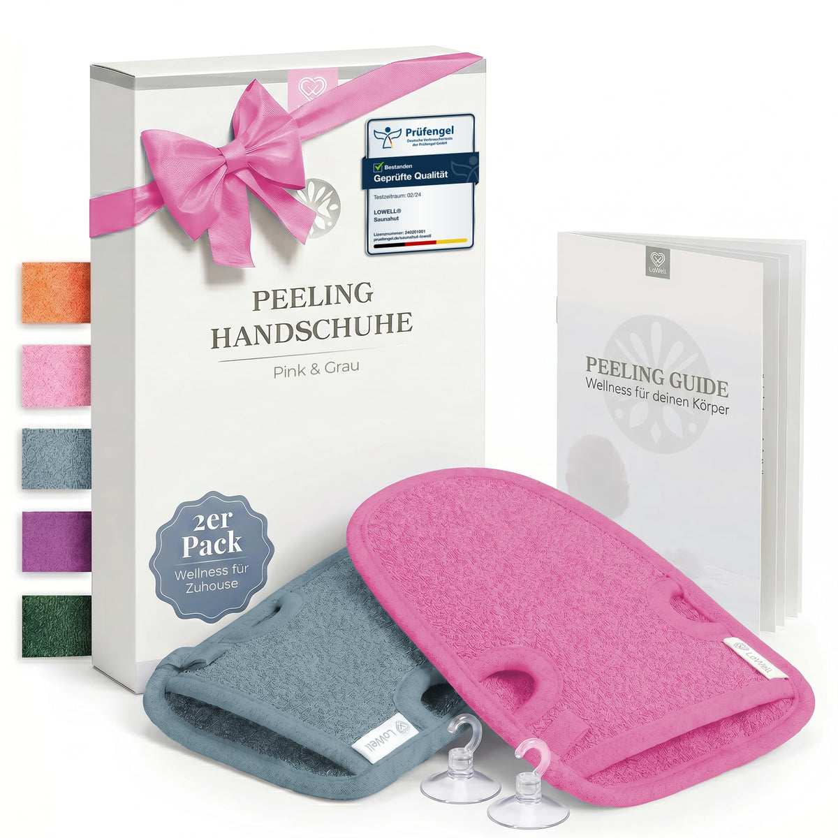 Zwei Peeling-Handschuhe in Pink und Grau vor Geschenkbox mit pinker Schleife, dazu zwei Saughaken